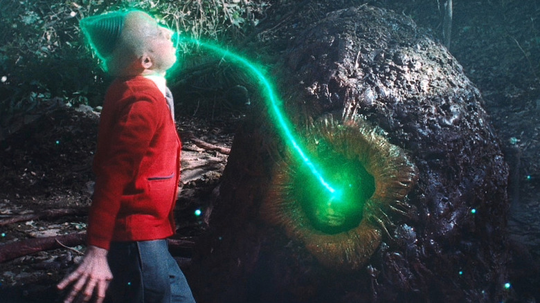 A boy is struck by a creature's beam