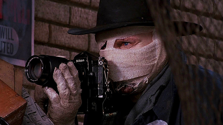 Darkman holding a camera