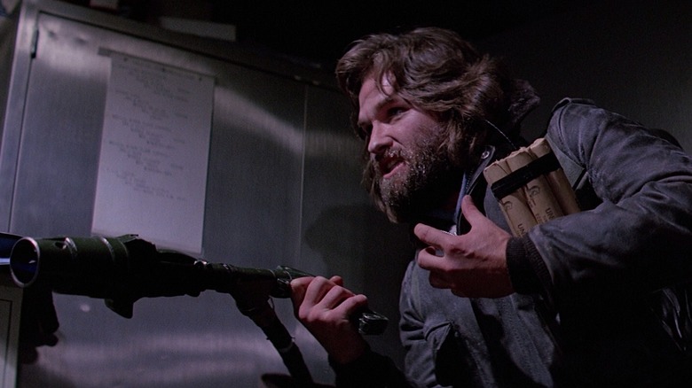 Kurt Russell holding flamethrower