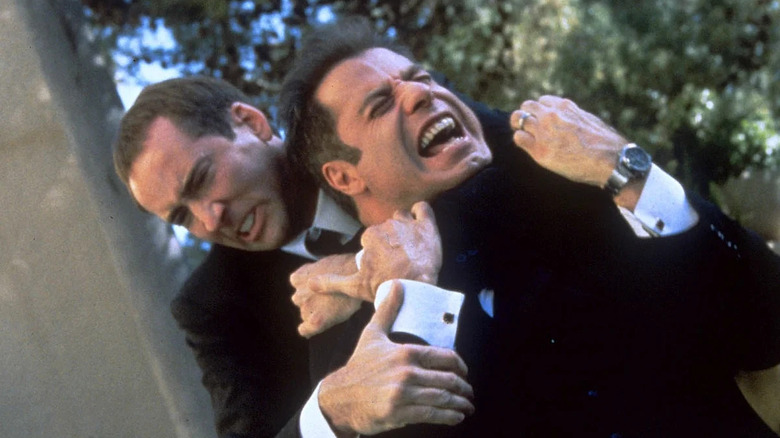 Nicolas Cage as Castor Troy holding John Travolta as Sean Archer in a headlock in "Face/Off."