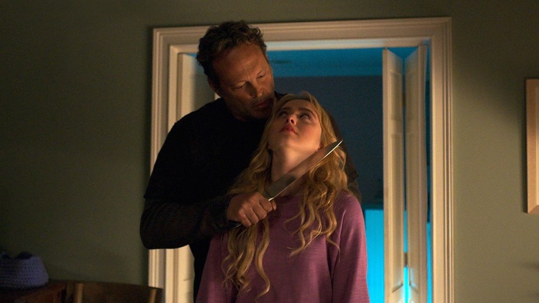 Vince Vaugh as The Butcher holding a knife to the neck of Kathryn Newton as Millie in "Freaky."