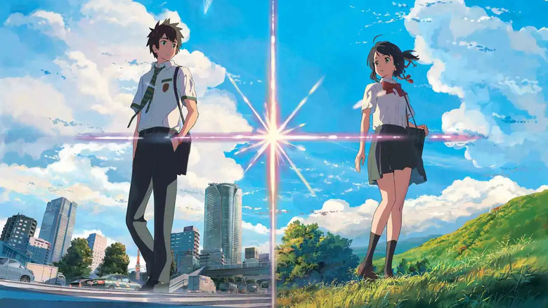 Taki Tachibana standing in Tokyo and Mitsuha Miyamizu standing in a field in "Your Name."