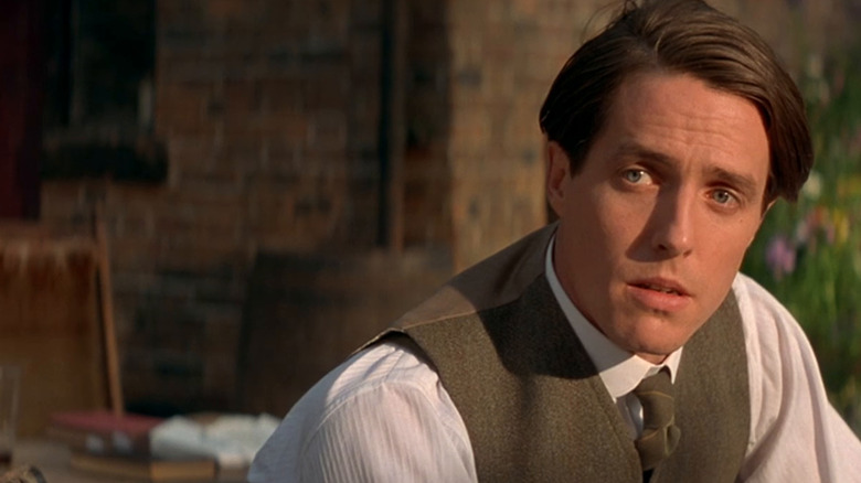 Hugh Grant leans forward