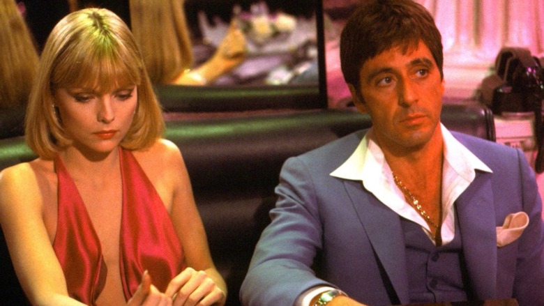 Elvira and Tony Montana sit in the club in Scarface