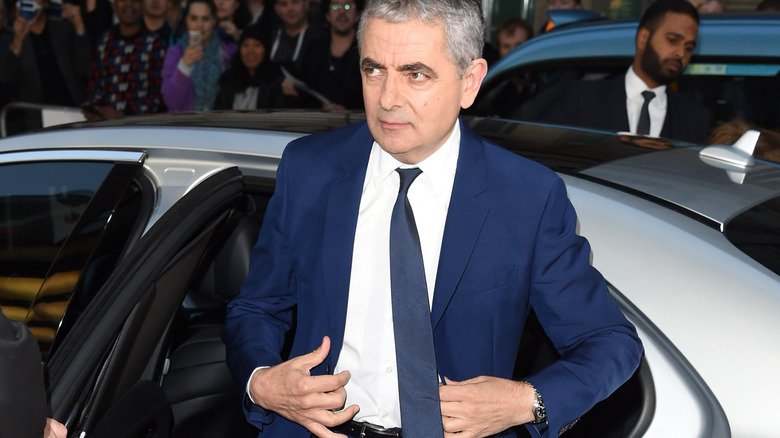 Rowan Atkinson getting out of car