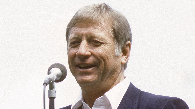 A smiling Mickey Mantle speaks into a microphone