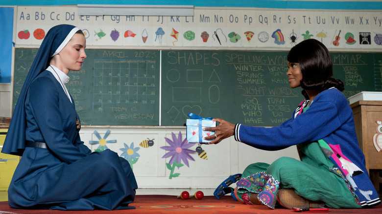 Kindergarten teacher giving Simone gift