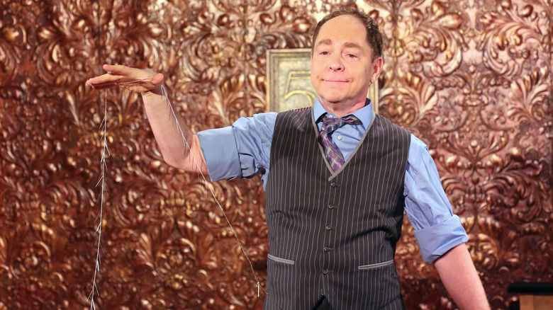 Teller performing magic trick