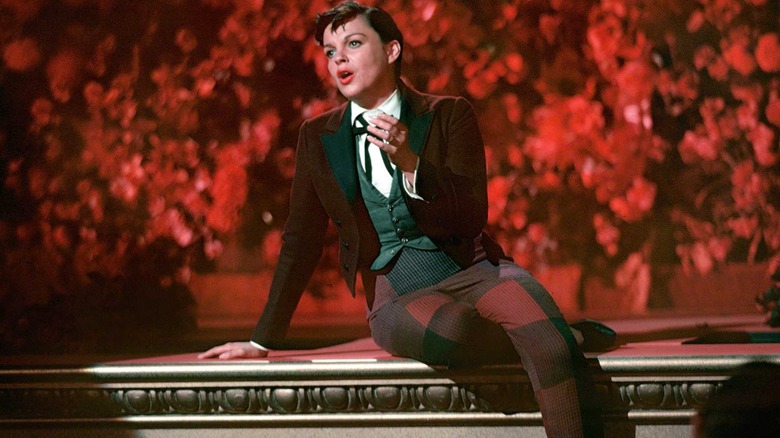 Judy Garland sitting on stage singing