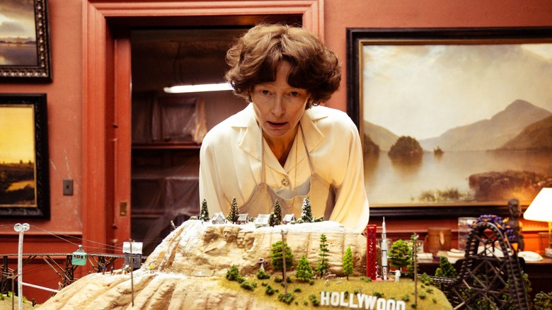 Mother looking over a model of California in The End (2024)