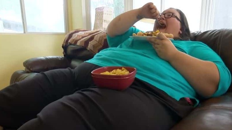 Dottie Perkins eating on couch