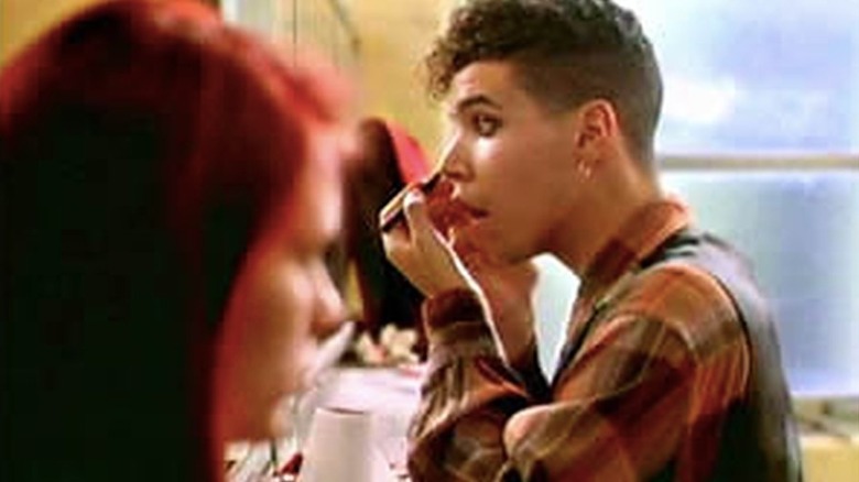 Rickie putting on eyeliner in the girls' bathroom