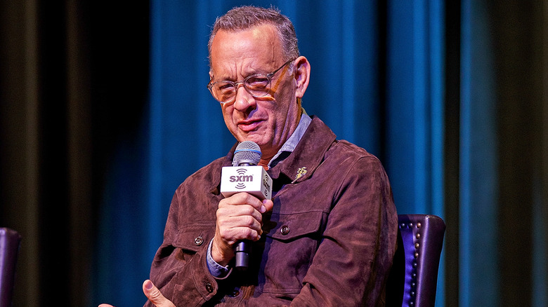 Tom Hanks holding a microphone