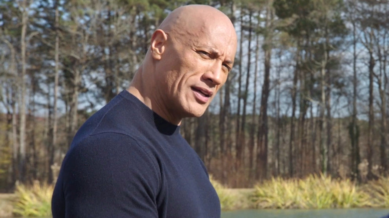 Dwayne Johnson standing by lake