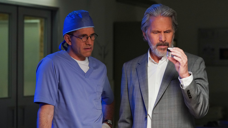 Brian Dietzen as Dr. Jimmy Palmer with Gary Cole as Alden Parker holding specimen jar in NCIS