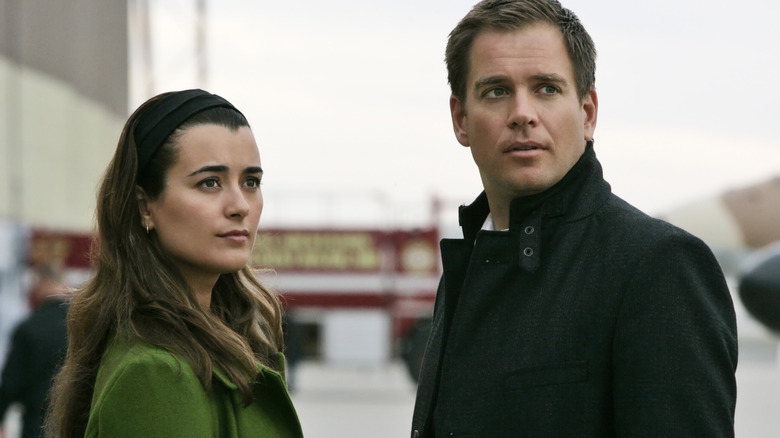 Cote de Pablo and Michael Weatherly standing outside in coats