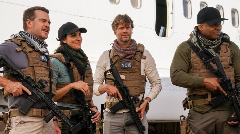 The cast of "NCIS: Los Angeles" in front of a plane