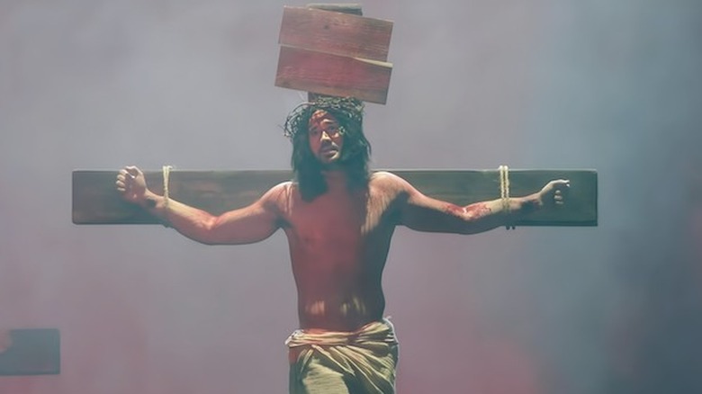 Gavin Stone as Jesus on the cross