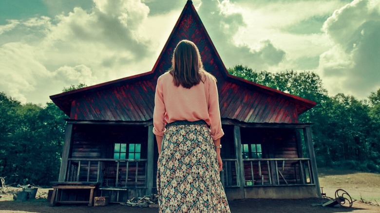 Woman standing in front of cabin