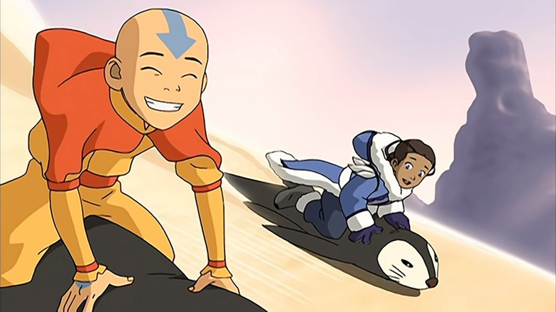 Katara and Aang penguin sledding