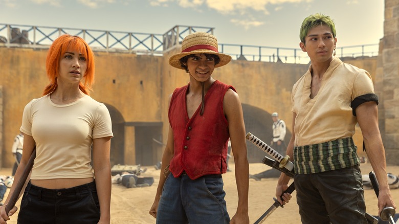 Nami, Luffy, and Zoro standing