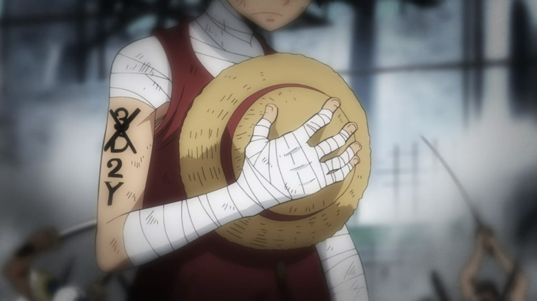 Luffy bearing a shoulder tattoo