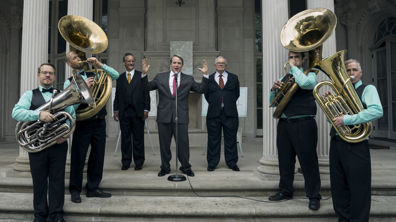 The Sacklers flanked by a brass band