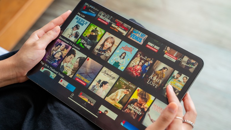 Woman browsing Netflix on tablet