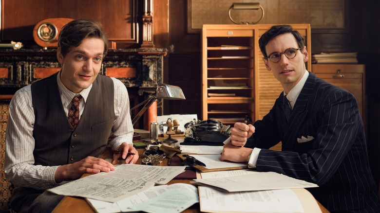 Albert Hirschman and Varian Fry sitting at table with papers