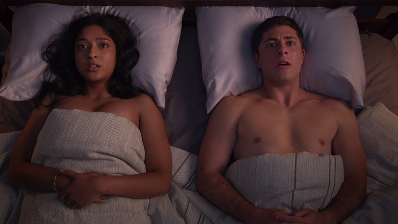 Devi and Ben lay in bed looking disturbed