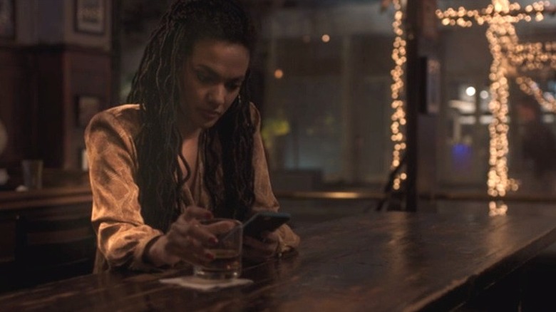 Dr. Helen Sharpe sitting at a bar