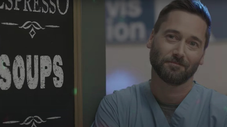 Ryan Eggold observing the action