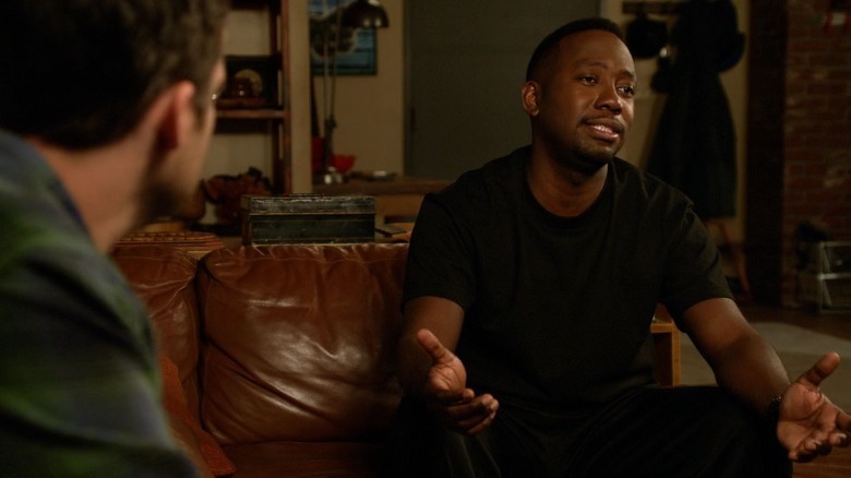 Winston sitting on the couch and talking to Nick Miller