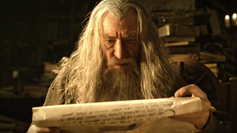 Gandalf looking scared as he reads parchment