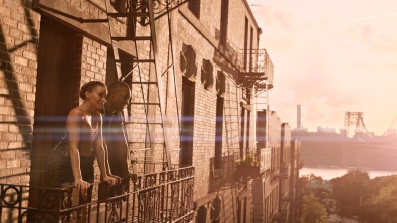 In The Heights, couple looking from balcony