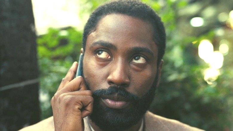 John David Washington talking on the phone as The Protagonist in "Tenet"