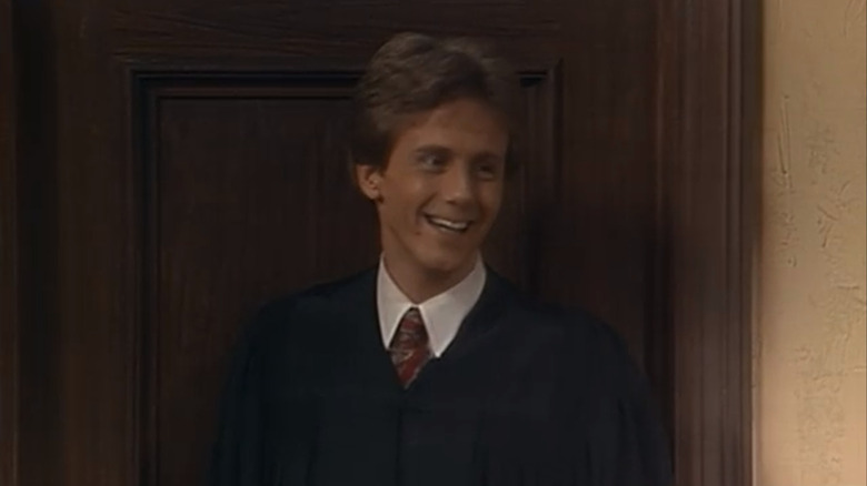 Harry in judge robes smiling