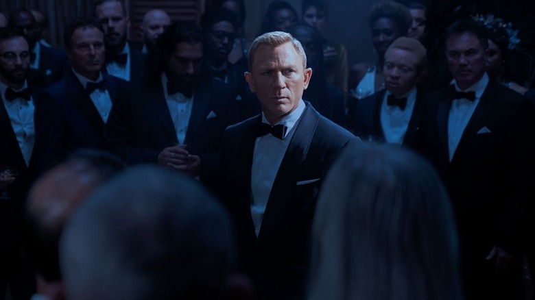 James Bond in room of people No Time to Die