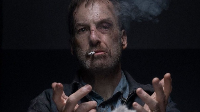 Bob Odenkirk as Hutch Mansell smoking a cigarette in Nobody