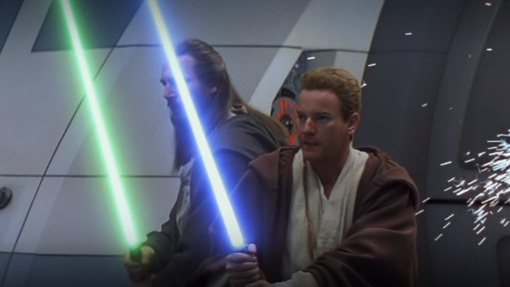 Liam Neeson as Qui-Gon Jinn and Ewan McGregor as Obi-Wan Kenobi brandish their lightsabers in Star Wars: The Phantom Menace