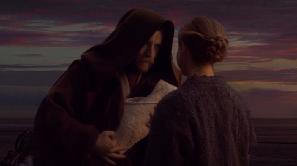 Ewan McGregor as Obi-Wan Kenobi giving an infant Luke Skywalker to Beru in Star Wars: Revenge of the Sith