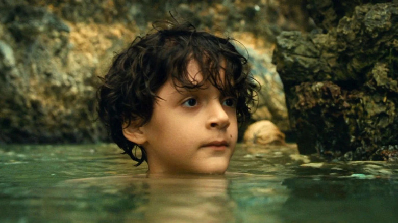 Young boy swimming in ocean