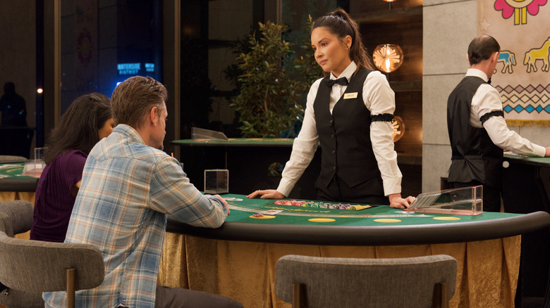 Olivia Munn as Dahlia dealing cards at a casino in The Gateway