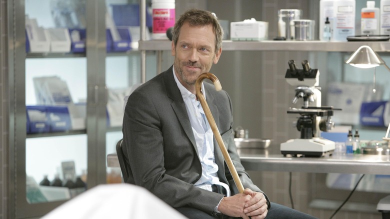 Dr. House smiling with cane