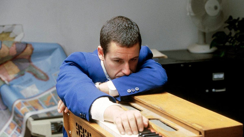 Barry Egan leaning on a harmonium