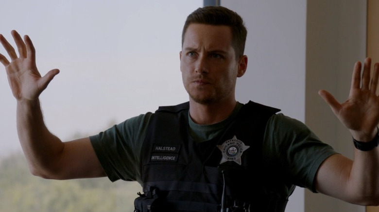 Detective Halstead raising hands 