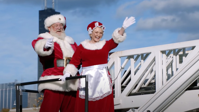 Santa and Mrs. Claus wave 