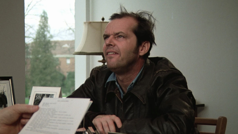 Jack Nicholson looks up over paper