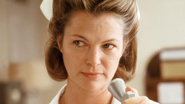 Nurse Ratched looks up from microphone