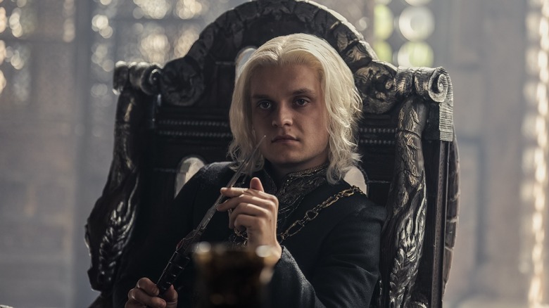 Aegon in chair holding knife